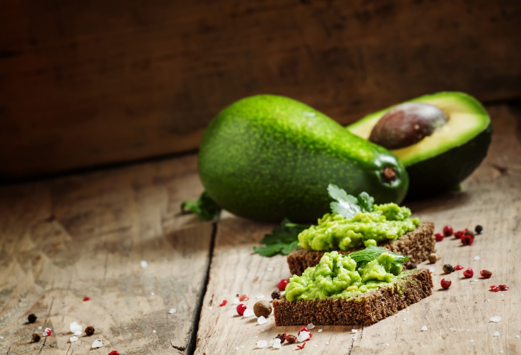 Sandwiches with black rye bread and avocado mousse with spices,