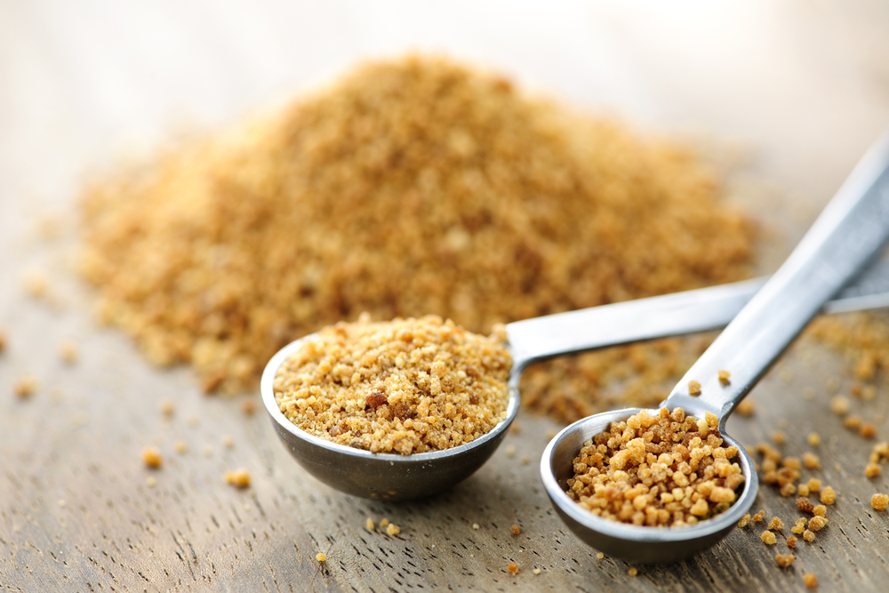 Coconut palm sugar in measuring spoons
