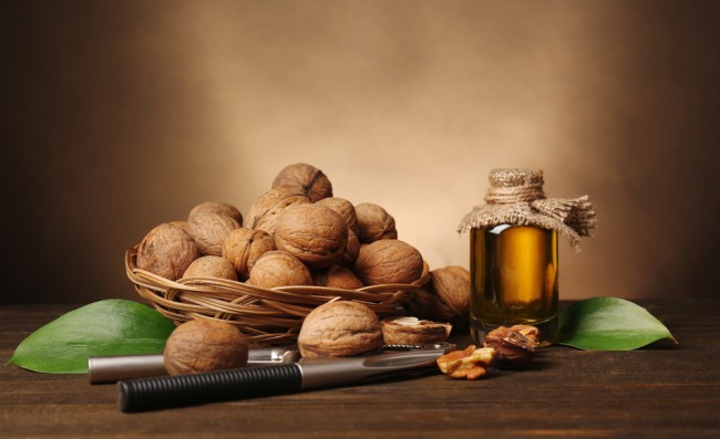 Walnut oil and nuts on wooden table