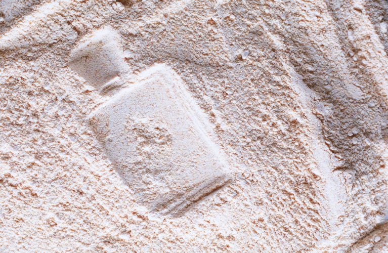 silhouette of perfume on powder